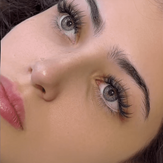 This custom wispy set was designed to enhance her natural eye shape while keeping lashes lightweight and healthy.